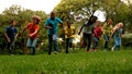 Cute pupils racing on the grass outside school