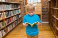 Green book lying open on polished wood floor in exposed brick library with wooden card catalog Royalty Free Stock Photo