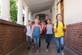Cute pupils running down the hall Royalty Free Stock Photo