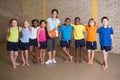 Cute pupils smiling at camera with PE teacher