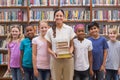 Cute pupils and teacher having class in library