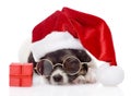 Cute puppy with red gift box and santa hat. isolated Royalty Free Stock Photo