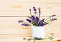 Cute purple flowers in a white pot. Bunch of Lavender flowers in white vase on wooden background, copy space Royalty Free Stock Photo