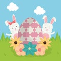 Cute rabbit with broken easter egg painted in the field Royalty Free Stock Photo