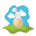 Cute rabbit with broken easter egg painted in the field Royalty Free Stock Photo