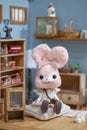 Cute rabbit doll. A pink kawaii rabbit felt doll sitting in pink living room with vintage setting. Toy photography