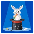 Cute rabbit in a magic hat gnaws carrots. Royalty Free Stock Photo