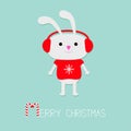 Cute rabbit in red pullover with snowflake. Headphone hat. Candy cane. Merry Christmas Greeting Card. Blue background. Flat design