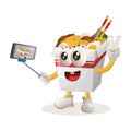 Cute ramen mascot takes a selfie with smartphone