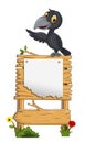 Cute raven cartoon waving with blank sign