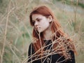 cute red-haired woman grass in field summer nature