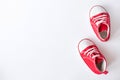 Cute red small sized canvas shoes top view on white background Royalty Free Stock Photo