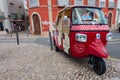 Cute red Tuk Tuk in the old town. Traditional three-wheel vehicles transport tourists to all famous attractions