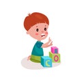 Cute redhead little boy sitting on the floor playing with block toys, kid learning through fun and play colorful cartoon