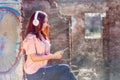 Enchanting Redhead Woman Lost in Music - Sunset Serenade on Ruins Wall