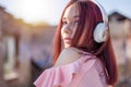 Charming Redhead Woman Enjoying Music in Sunset