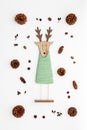 Cute reindeer chrismas decoration flat on white background. Xmas composition with pine cones and a reindeer.