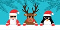 cute reindeer santa claus and penguin with sunglasses christmas cartoon Royalty Free Stock Photo