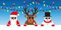 Cute reindeer santa and snowman cartoon with sunglasses and christmas fairy lights Royalty Free Stock Photo