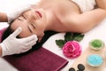 Cute relaxed young woman laying in spa salon with closed eyes Royalty Free Stock Photo