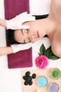 Cute relaxed young woman laying in spa salon with closed eyes Royalty Free Stock Photo