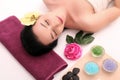 Cute relaxed young woman laying in spa salon with closed eyes Royalty Free Stock Photo