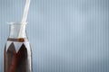 Cute retro soda bottle with cola and straw and background Royalty Free Stock Photo