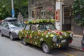 Cute retro vehicle covered by flowers, flower power