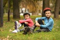 Cute roller skaters sitting on grass