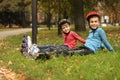 Cute roller skaters sitting on grass