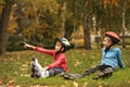 Cute roller skaters sitting on grass Royalty Free Stock Photo