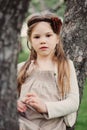 Cute romantic child girl in beige natural dress
