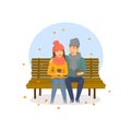 Cute romantic couple sitting on a bench in the park, autumn falling leaves scene