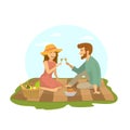 Cute romantic dating couple in love sitting on a plaid blanket in the park, at picnic