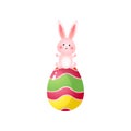 Cute rosy easter bunny on top of big painted egg isolated on white background