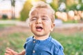 Cute and sad little boy crying having a tantrum at the park on a sunny day Royalty Free Stock Photo