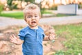 Cute and sad little boy crying having a tantrum at the park on a sunny day Royalty Free Stock Photo