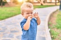 Cute and sad little boy crying having a tantrum at the park on a sunny day Royalty Free Stock Photo