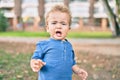 Cute and sad little boy crying having a tantrum at the park on a sunny day Royalty Free Stock Photo