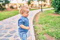 Cute and sad little boy crying having a tantrum at the park on a sunny day Royalty Free Stock Photo