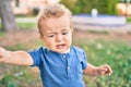 Cute and sad little boy crying having a tantrum at the park on a sunny day Royalty Free Stock Photo