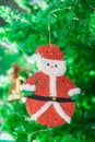 Cute Santa claus doll and gold bell ornament on Christmas Tree Royalty Free Stock Photo