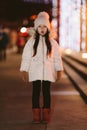 Cute scared lost little girl in a big city in the evening in winter