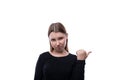 Cute school age girl dressed in black clothes is indignant on a white background