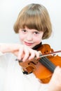 Cute school boy playing violin, close up portrait