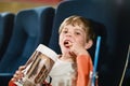 Cute school boy watching cartoon movie in the cinema. Leisure and activity for family with kids. Happy child with Royalty Free Stock Photo