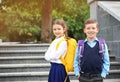 Cute school children with backpacks near stairs Royalty Free Stock Photo