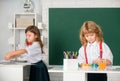 Cute school friends kids drawing and painting at school. Friendly boy an girl funny pupils draw. Friendship in school Royalty Free Stock Photo