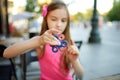 Cute school girl playing with colorful fidget spinner Royalty Free Stock Photo