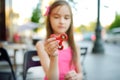 Cute school girl playing with colorful fidget spinner Royalty Free Stock Photo